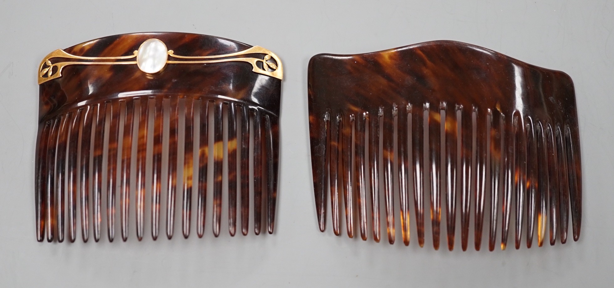 An early 20th century 9ct and mother of pearl mounted tortoiseshell hair comb, by Murrle Bennett & Co, width 93mm and one other tortoiseshell hair comb by Asprey.